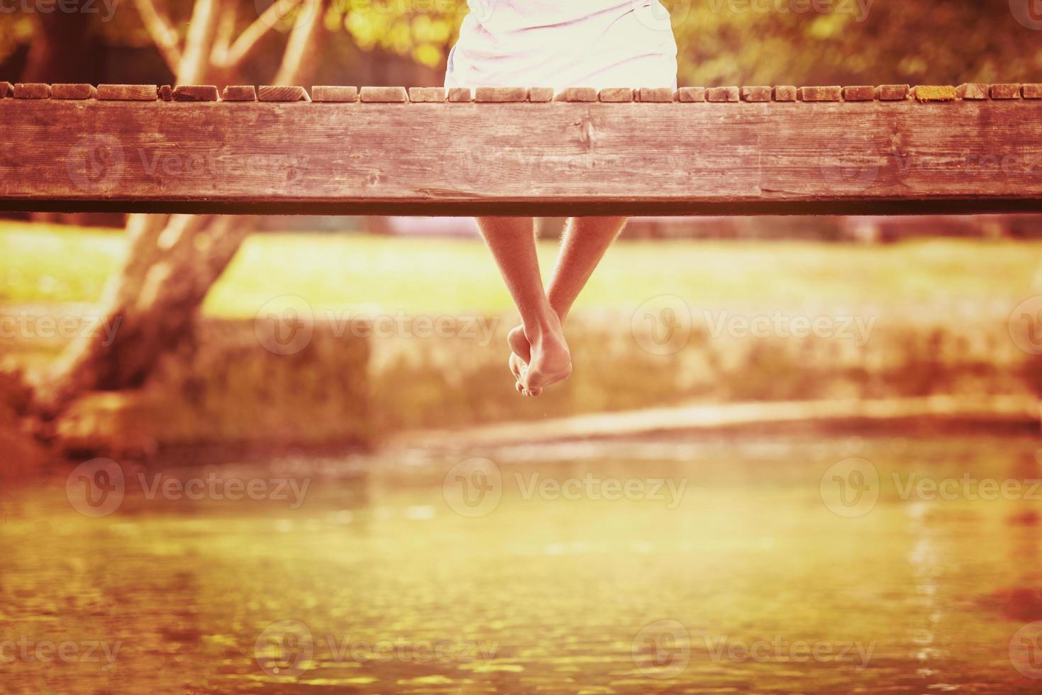 people sitting at wooden bridge photo