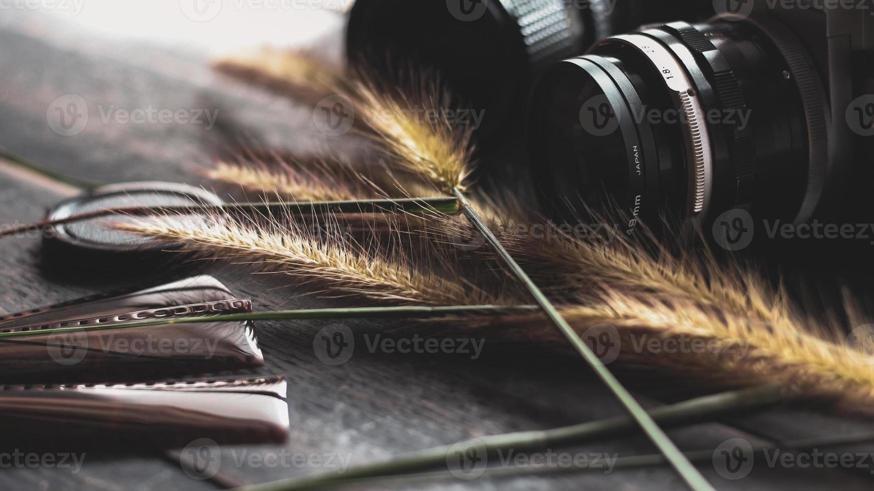 Retro film camera and negative film on a black wooden table photo