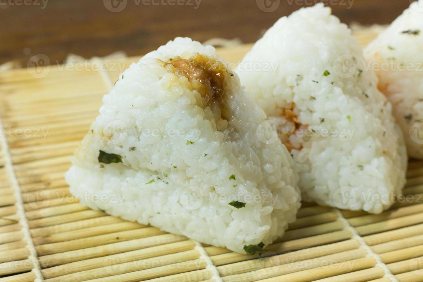 The Japanese food Onigiri  white rice formed into triangular or cylindrical shapes and often wrapped in nori. photo