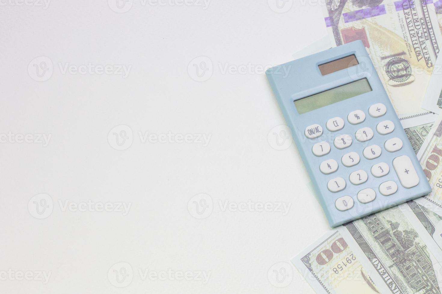 blue calculator and banknotes on white back ground. photo