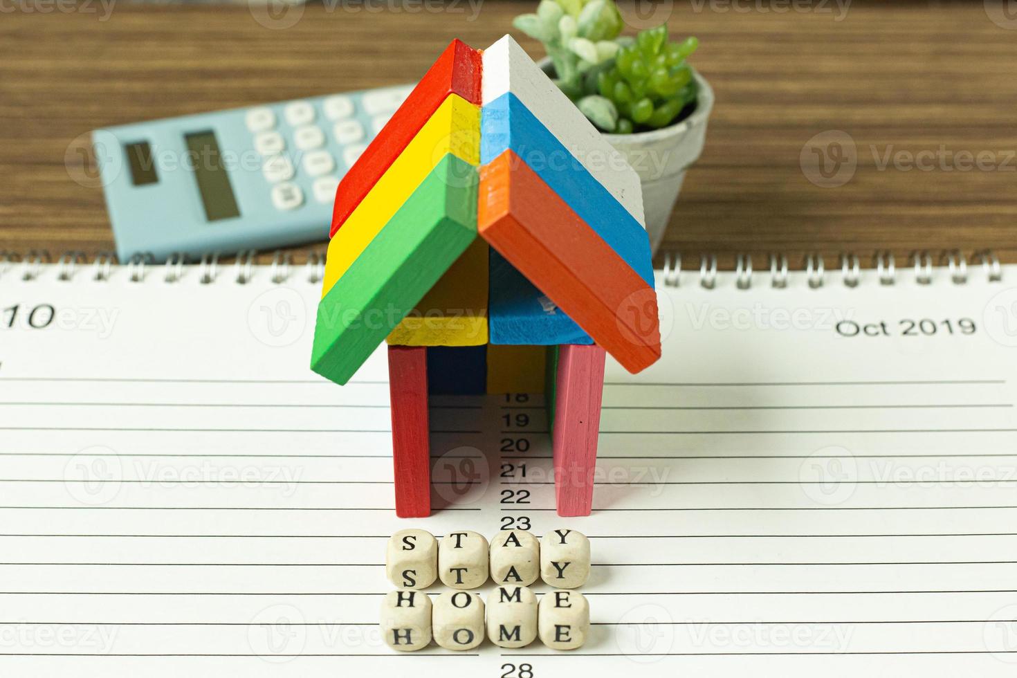 stay home on wood cube and home toy for social distancing content. photo