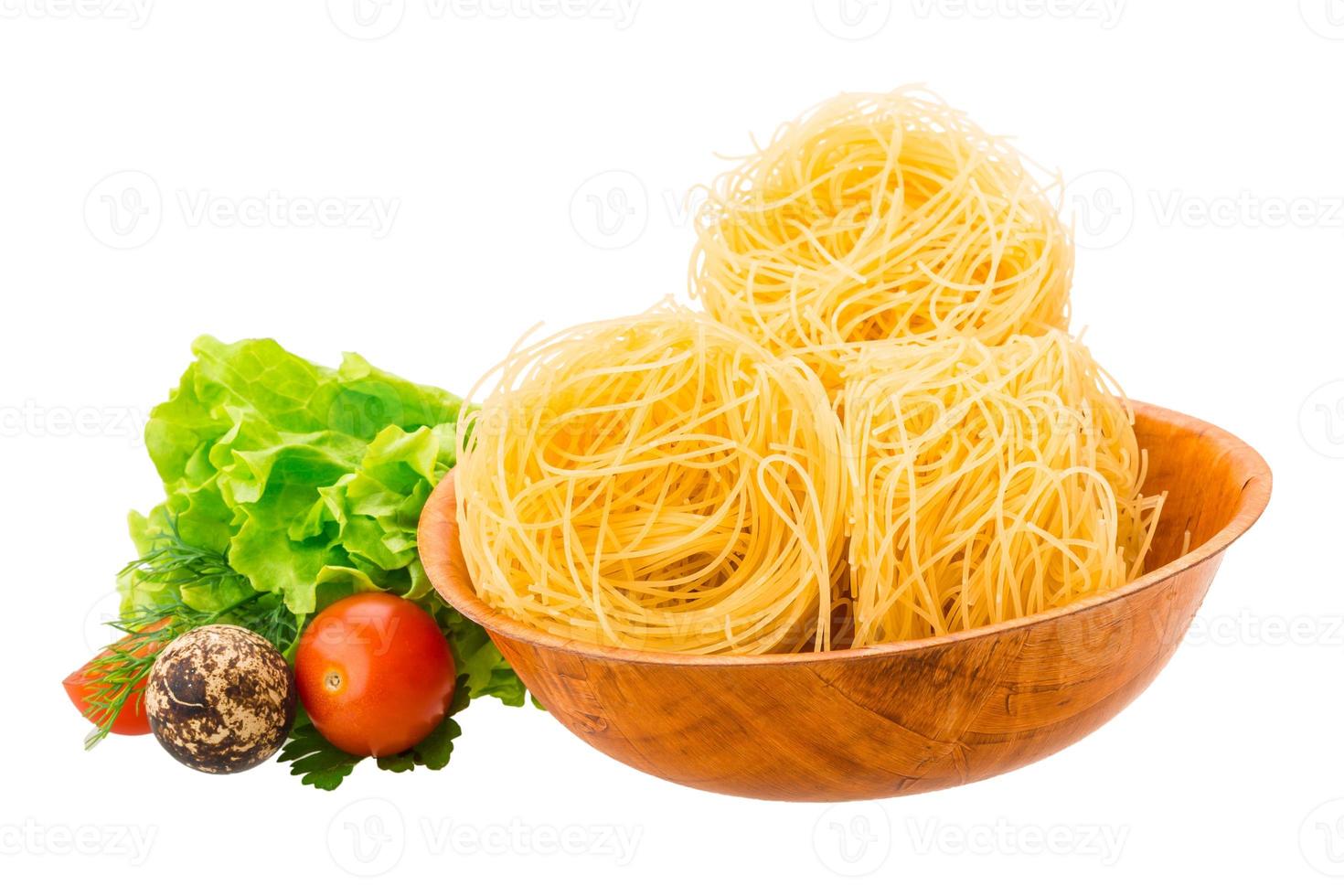 Tagliatelle in a bowl on white background photo