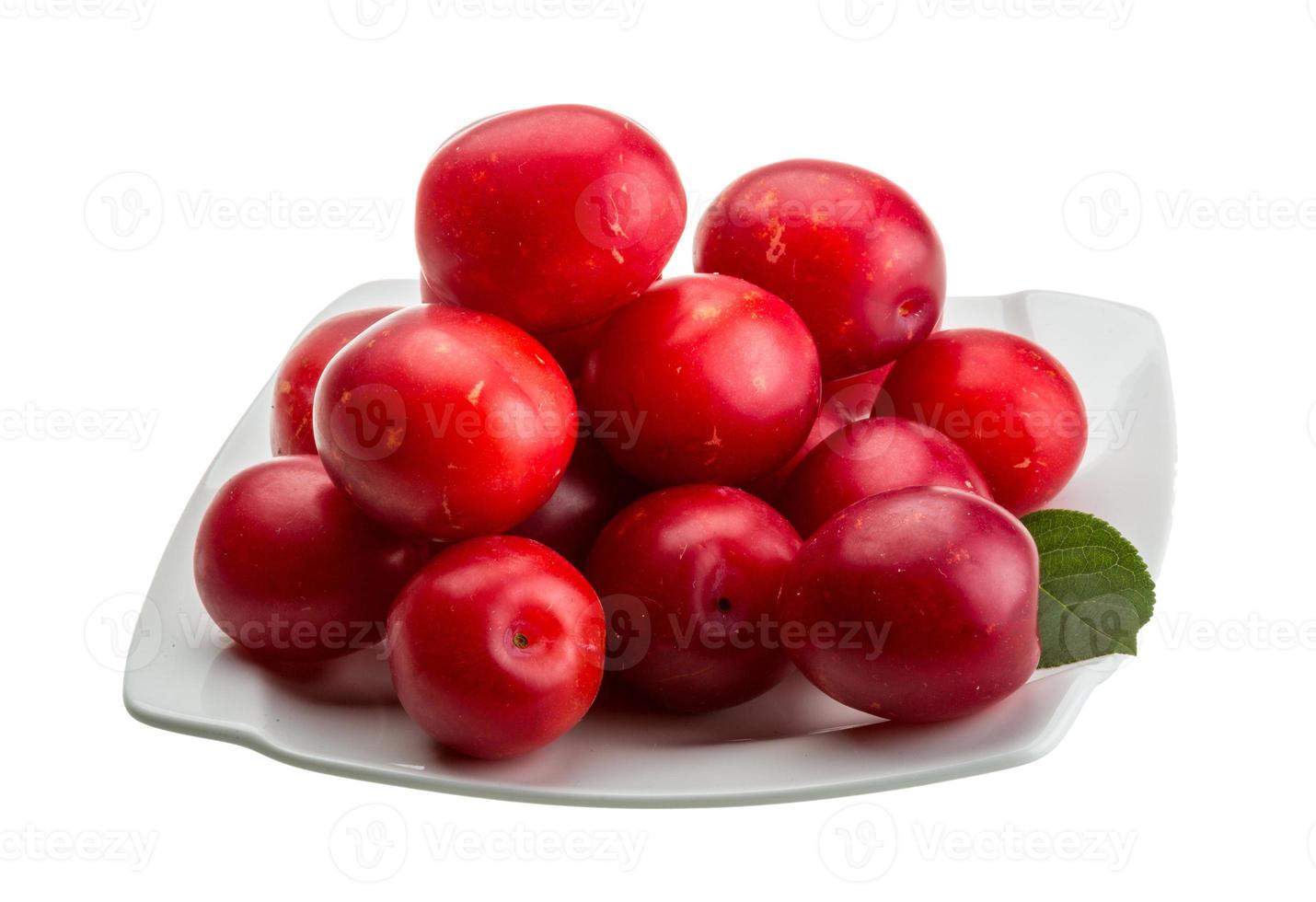 Damson plum on the plate and white background photo