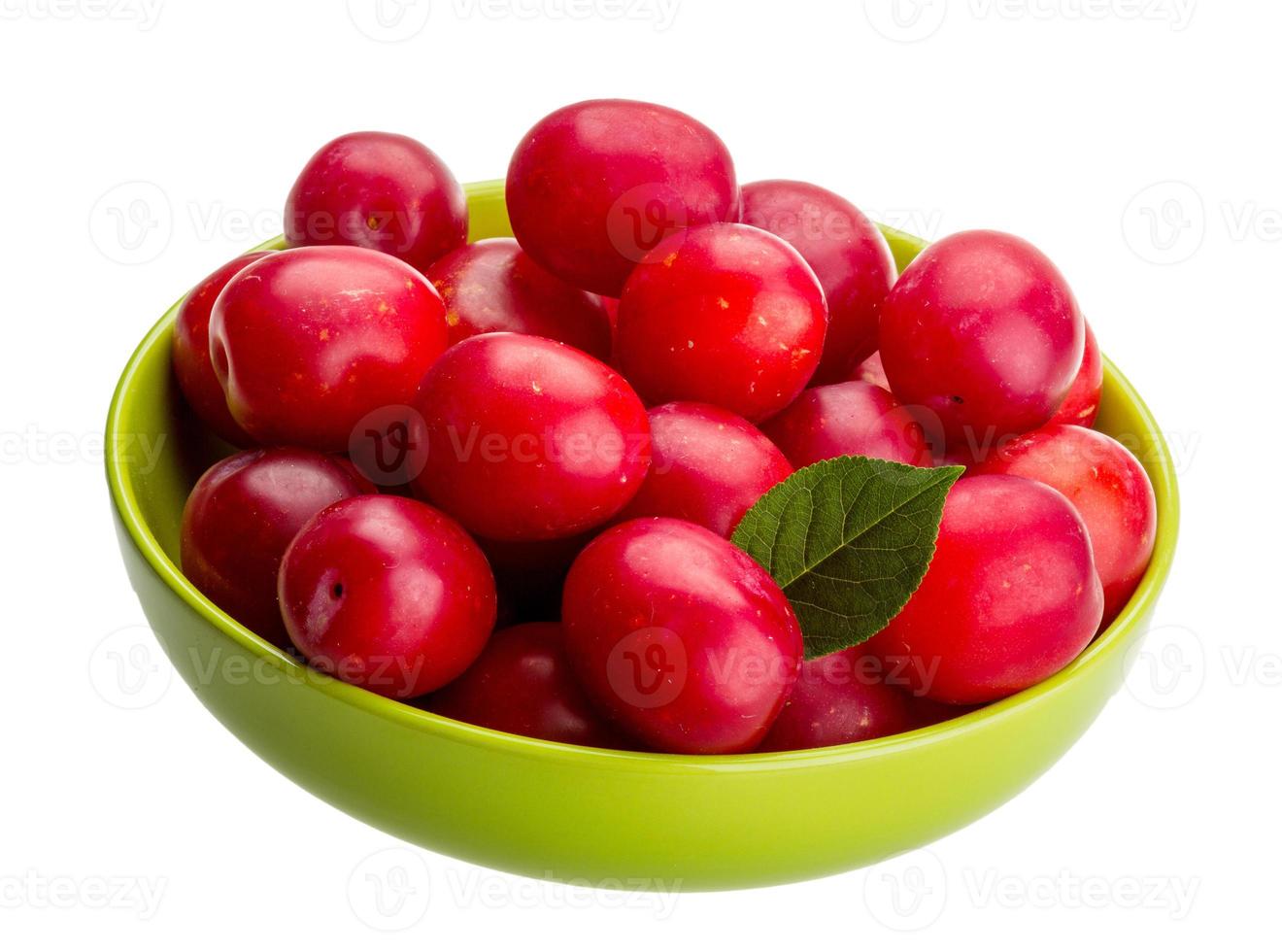 Damson plum in a bowl on white background photo