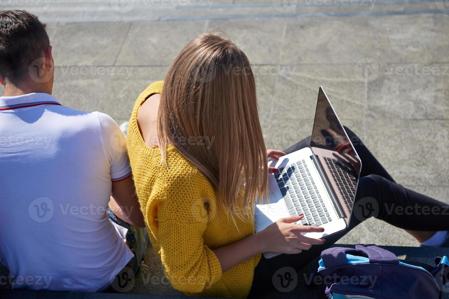 students outside sitting on steps photo