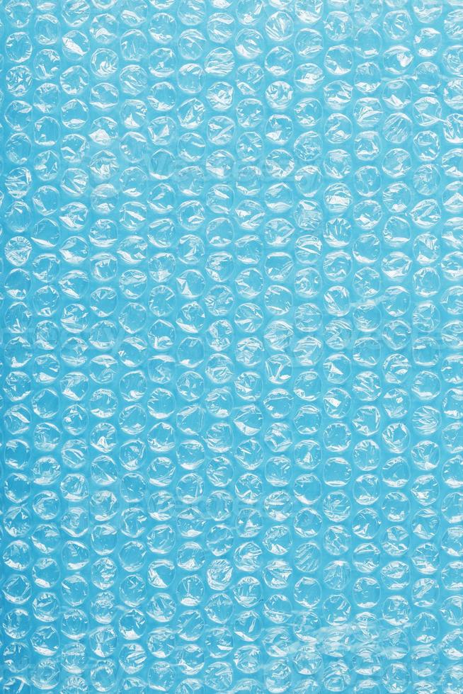 Packing bubble wrap for parcels on a blue background in full screen photo