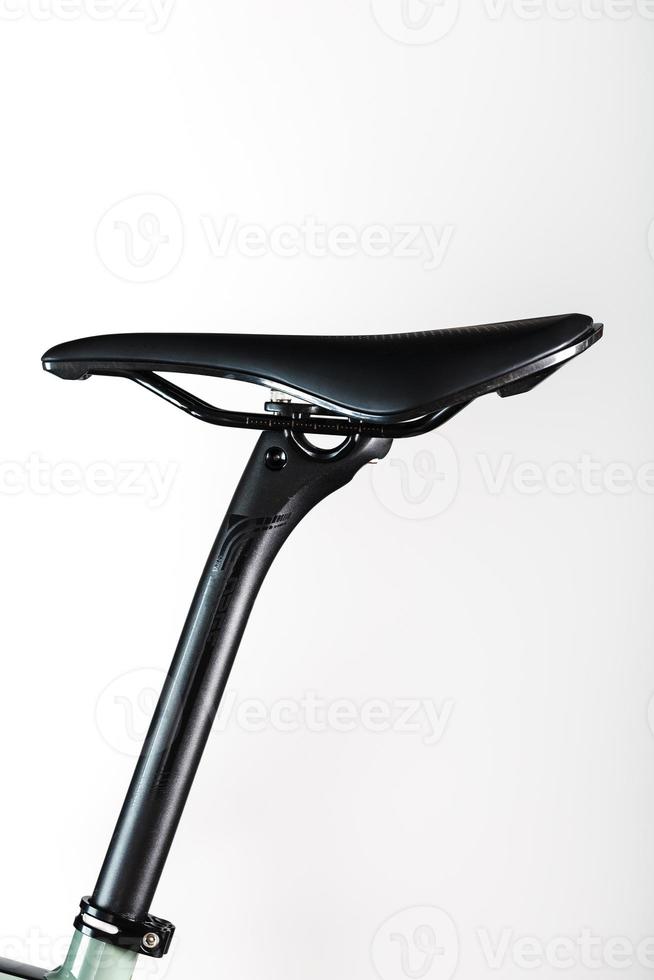 Bicycle saddle on a light background accessories for bike repair and tuning photo