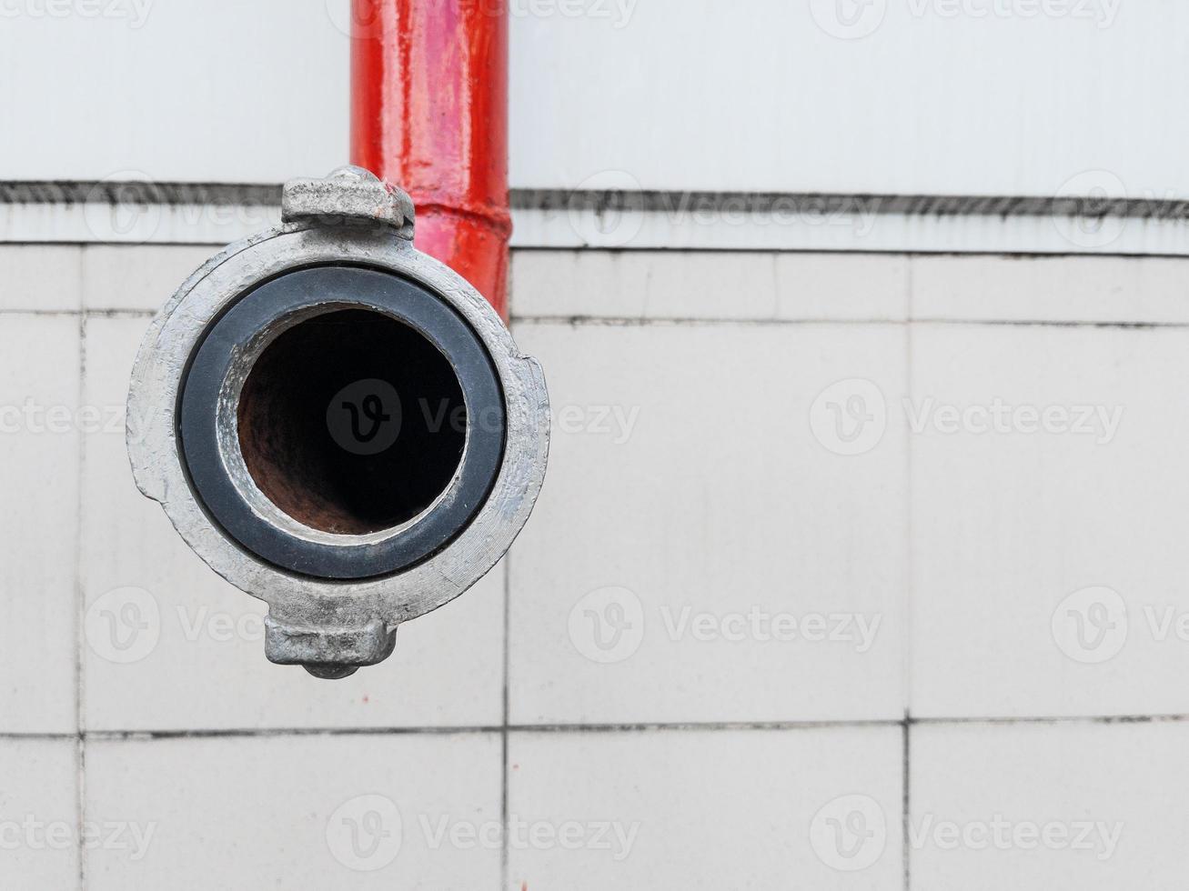 Red fire-fighting pipeline with a close-up lock photo