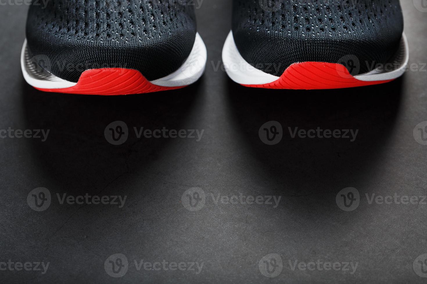 Black running shoes with mesh and black laces close-up on a dark background photo