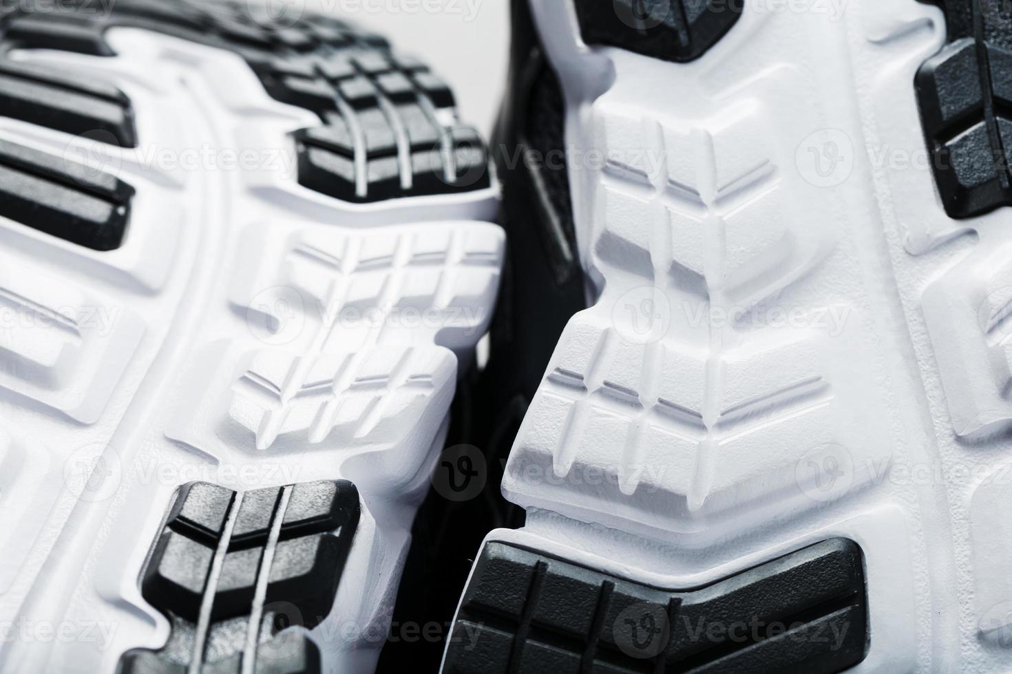 The black and white sole of trendy sports sneakers is a close-up in full screen. photo