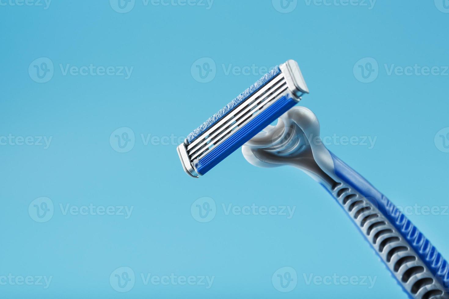 Blades of a new shaving machine on a blue background photo