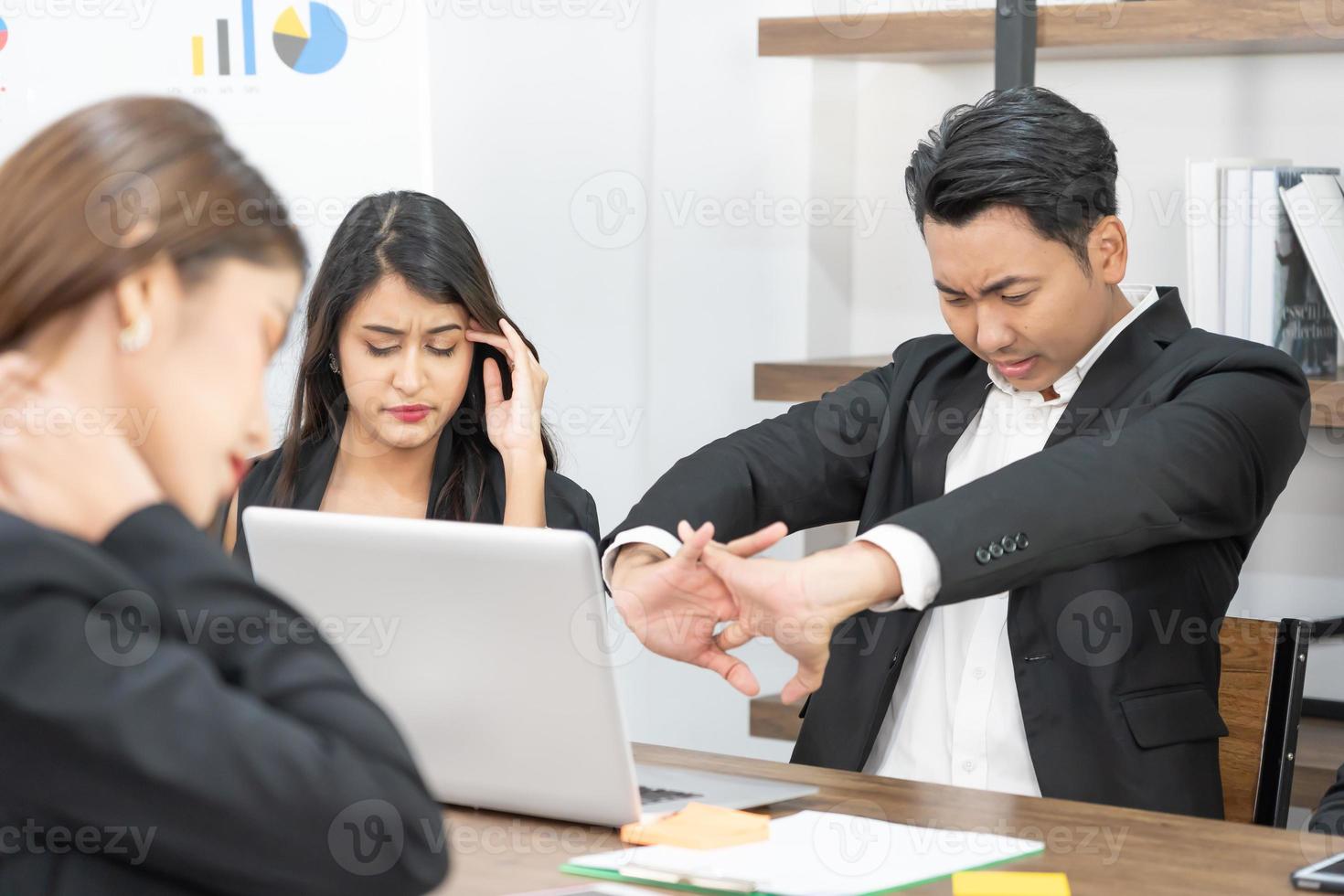 Business team members sleeping on desk and chairs. A business team is tired from a long meeting. photo