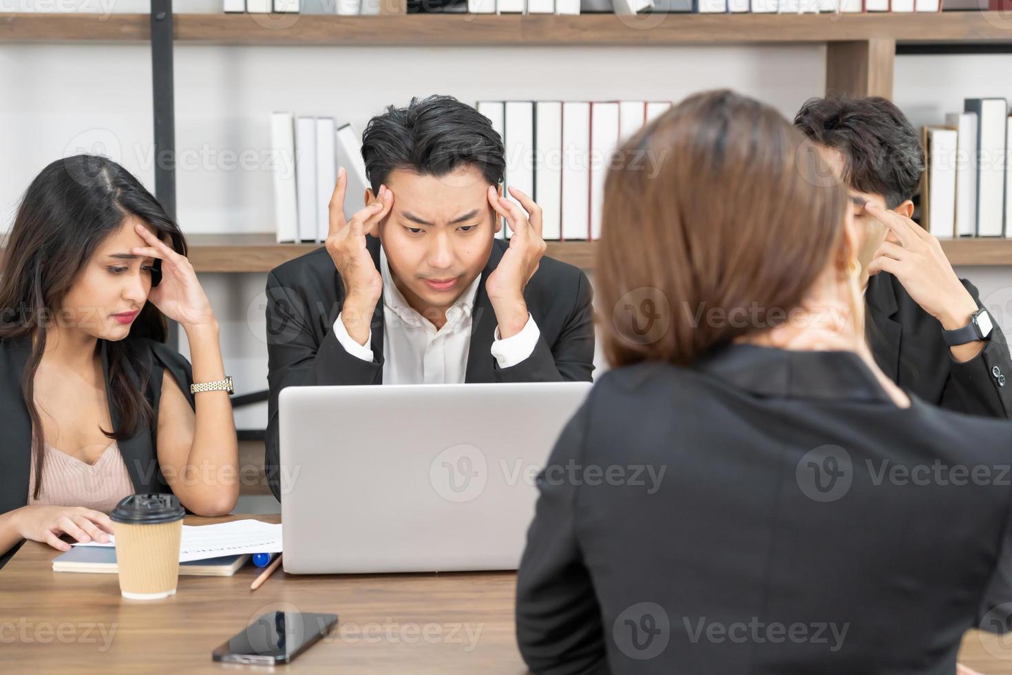 Business team members sleeping on desk and chairs. A business team is tired from a long meeting. photo