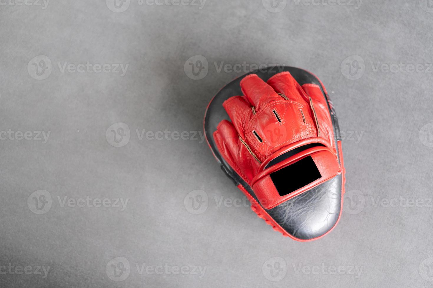 Red Target Focus Punch Pad Glove in gym. photo