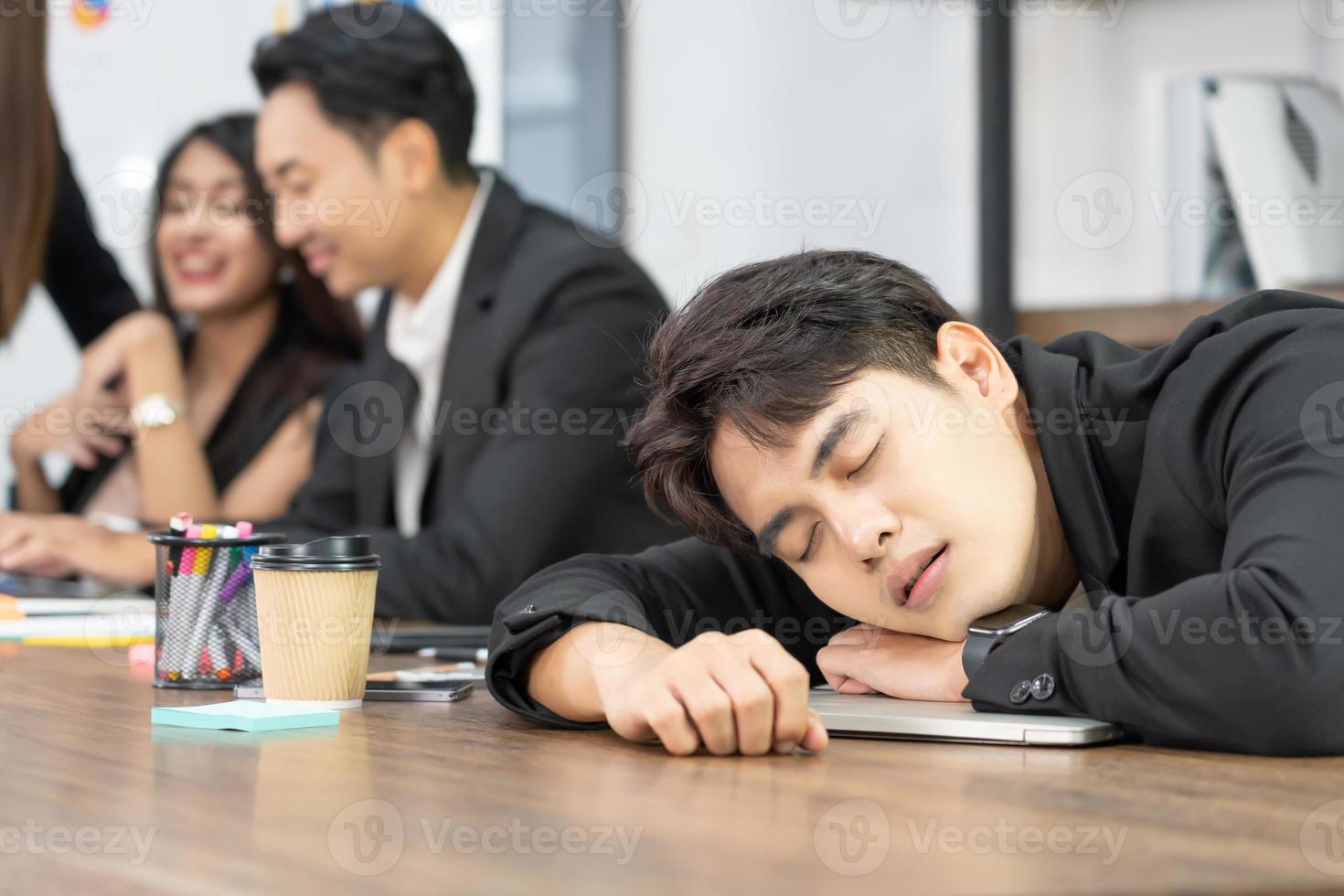 Businessman knock down on desk. overload working or deteriorating health or failure business down trend. Sleeping on the Desk at Work. photo