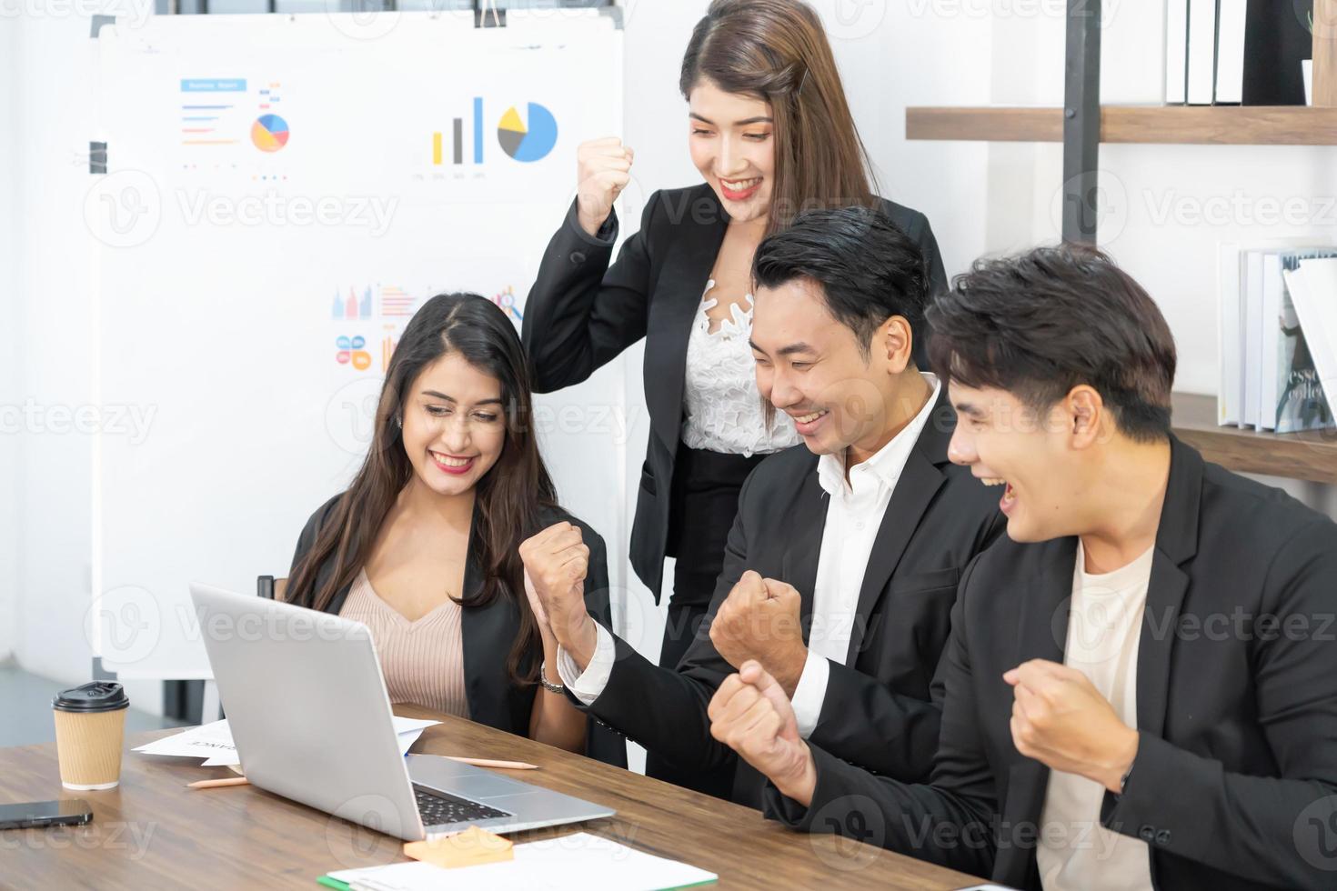Businesspeople triumphing because of the financial growth of company. Happy smiling businesspeople triumphing with raised fists. photo