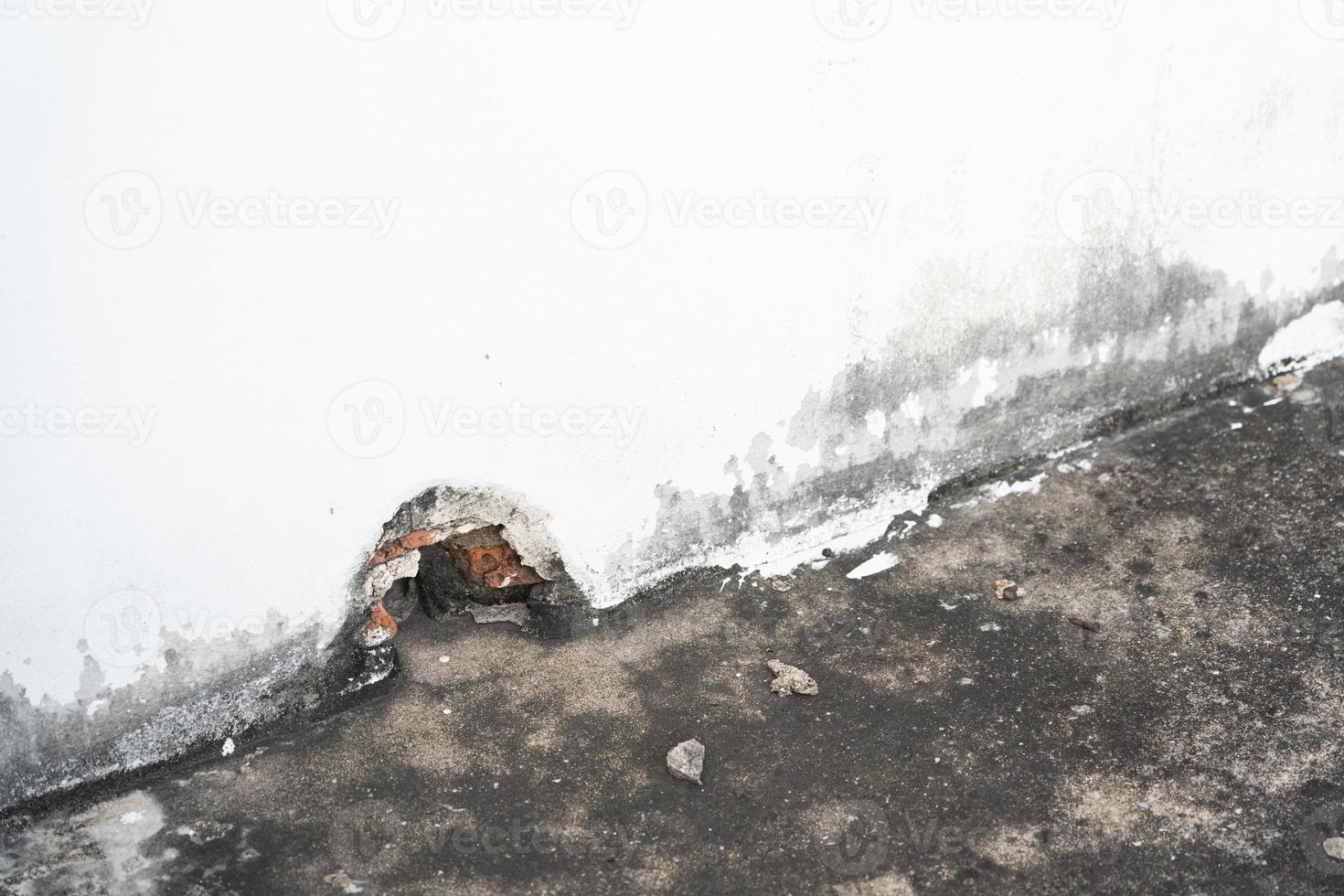 Water damaged ceiling roof in an old house. Water damage building interior. Ceiling house broken. Ceiling concrete crack and exposed the rusty steel bar frame. photo