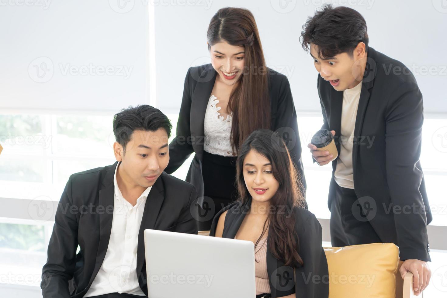 Happy office concept - concentrated business team with laptop computers in office. Happy Business team of entrepreneurs working together. Funny moment in business. photo