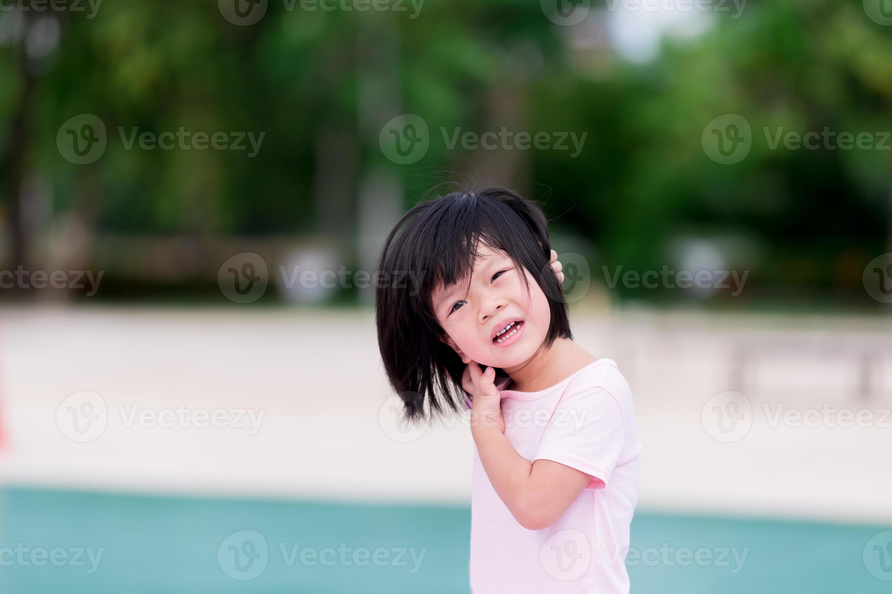 Asian child is scratching his neck due to itching. Hot weather in the