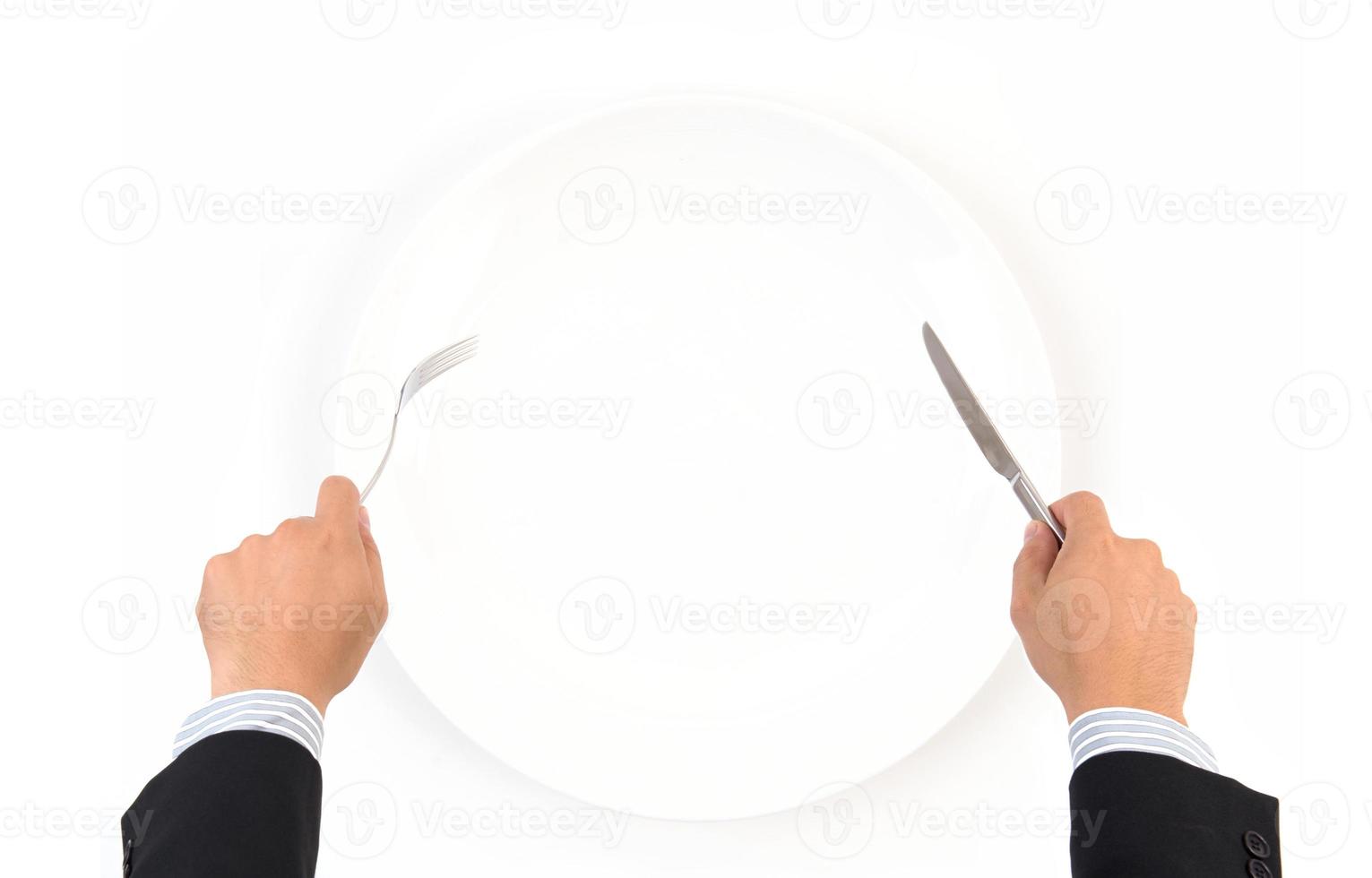 hand hold fork and knife with white plate photo