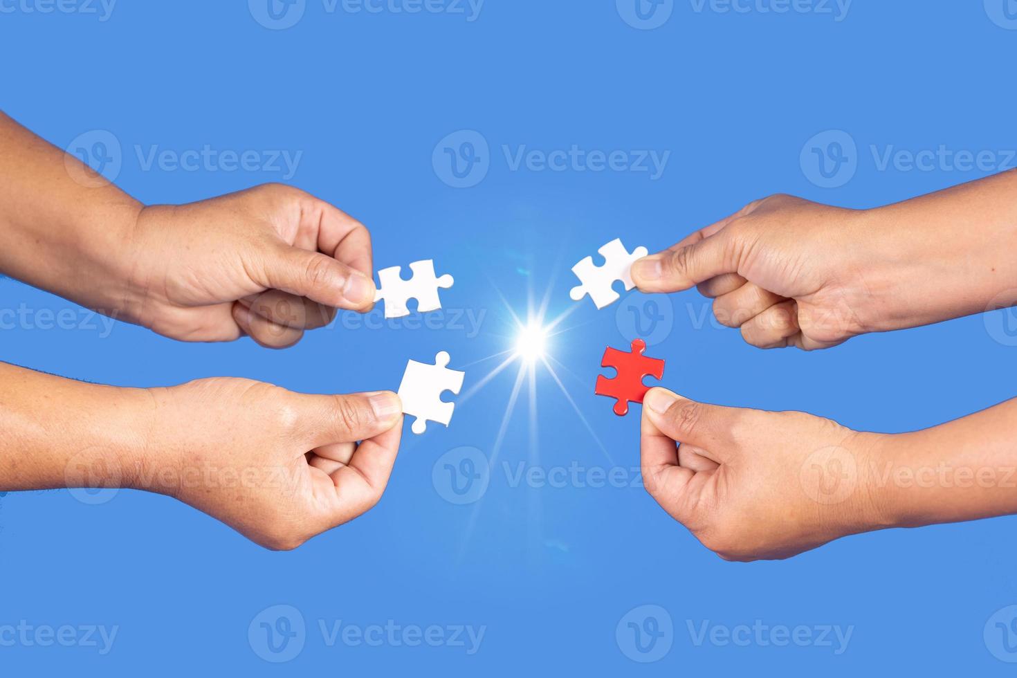 Hands holding jigsaw puzzles piece with clear blue background, success business, solution strategy, teamwork partnership concept photo