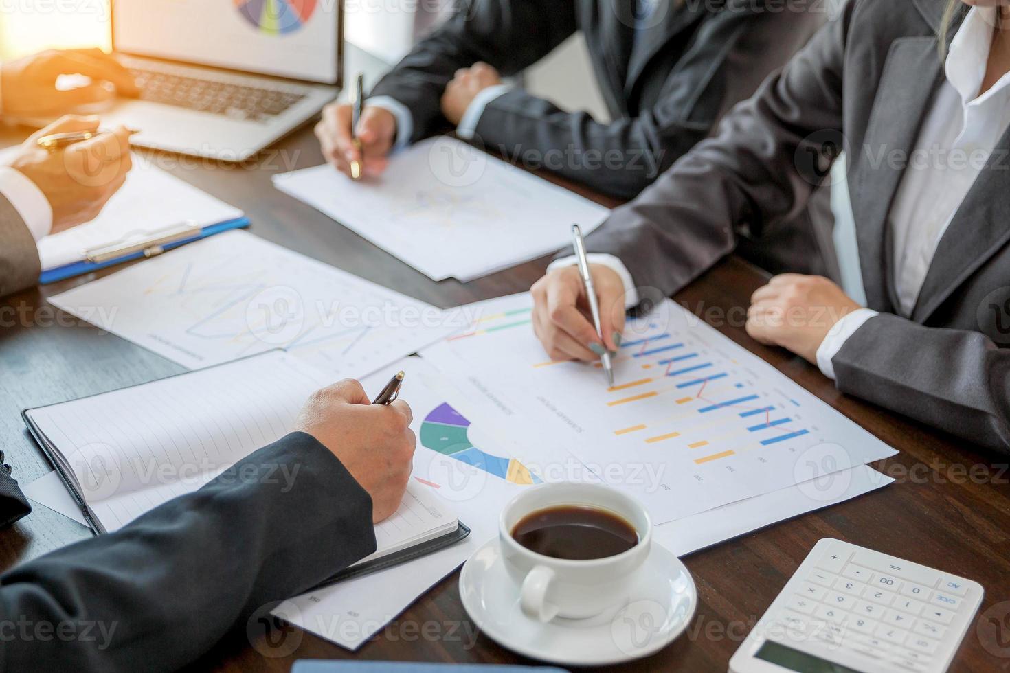 Group professional business people person working together to analyze in office, work together to discuss company financial statistics report, brainstorm ideas, and graph datum documents on the table. photo