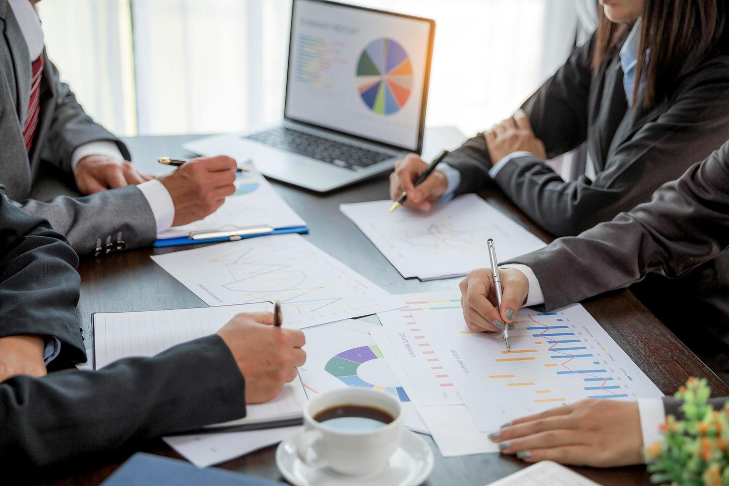 Group professional business people person working together to analyze in office, work together to discuss company financial statistics report, brainstorm ideas, and graph datum documents on the table. photo