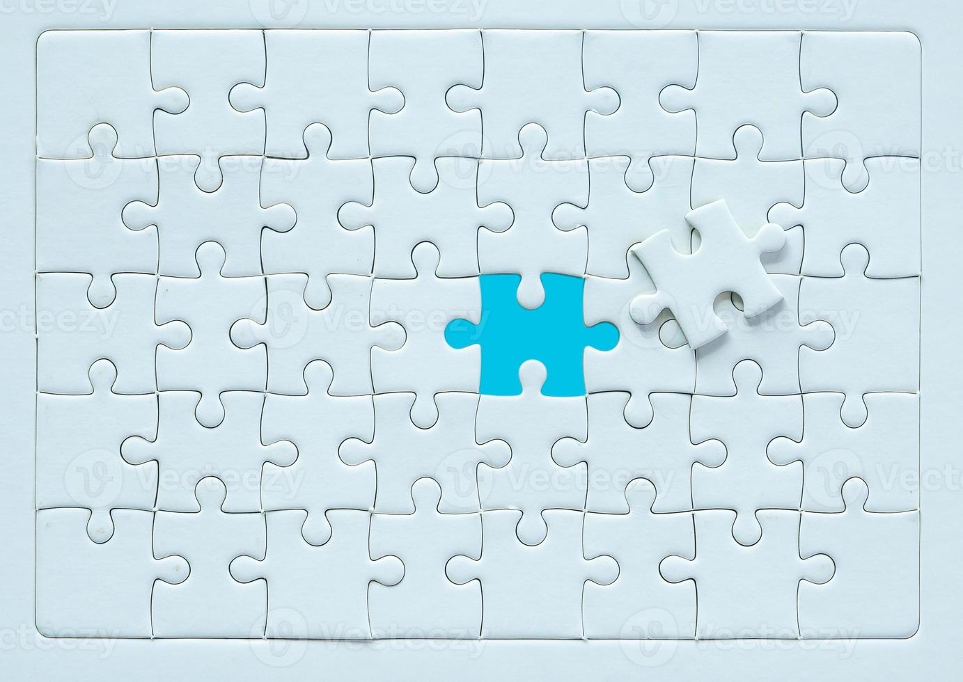 White part of jigsaw puzzle pieces on blue background. concepts of problem solving, business success, teamwork, Team playing jigsaw game incomplete, Texture photo with copy space for text