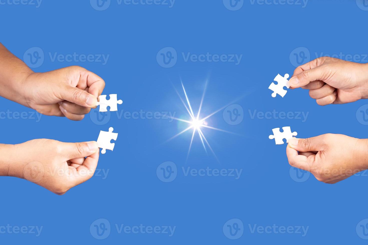 Hands holding jigsaw puzzles piece with clear blue background, success business, solution strategy, teamwork partnership concept photo