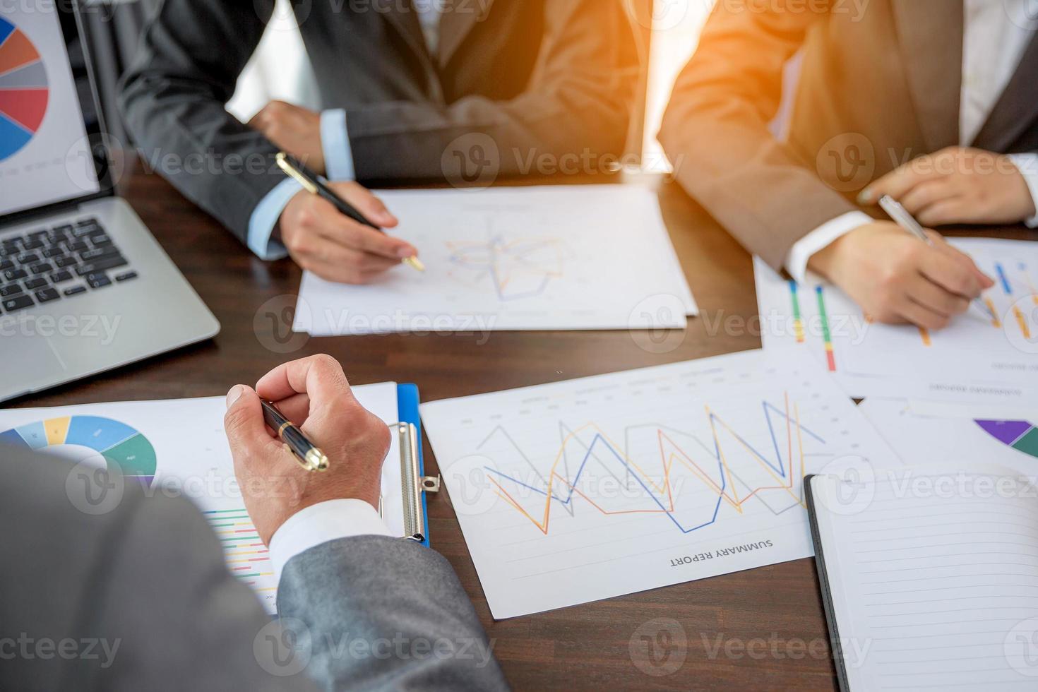 Group professional business people person working together to analyze in office, work together to discuss company financial statistics report, brainstorm ideas, and graph datum documents on the table. photo