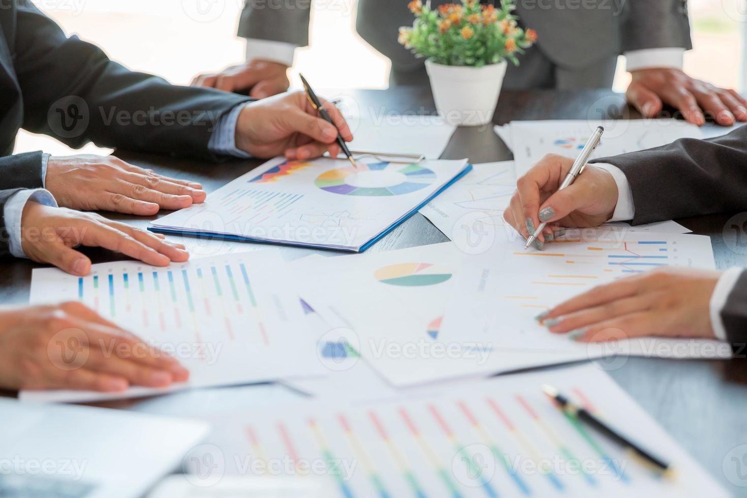 Group professional business people person working together to analyze in office, work together to discuss company financial statistics report, brainstorm ideas, and graph datum documents on the table. photo