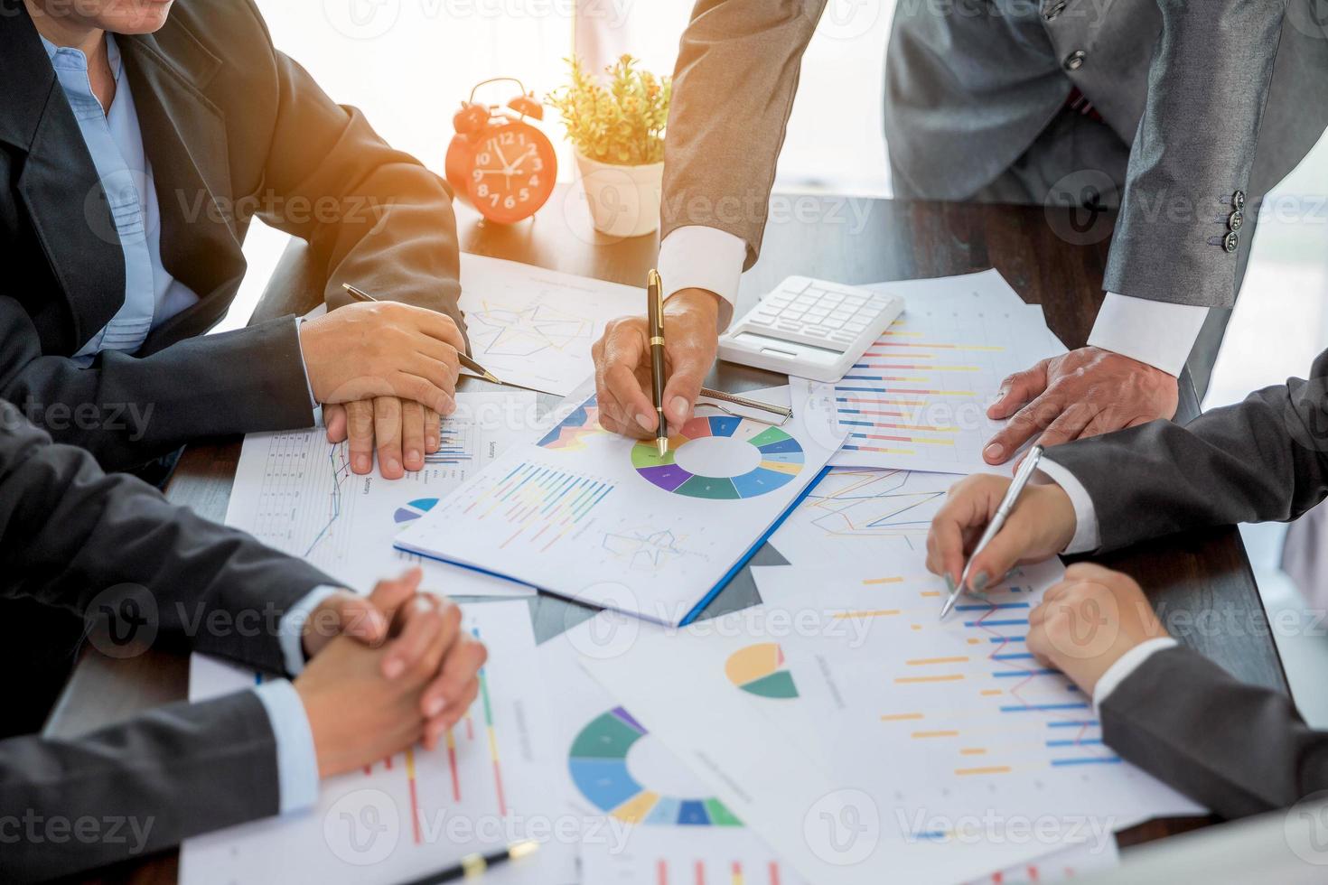 Group professional business people person working together to analyze in office, work together to discuss company financial statistics report, brainstorm ideas, and graph datum documents on the table. photo