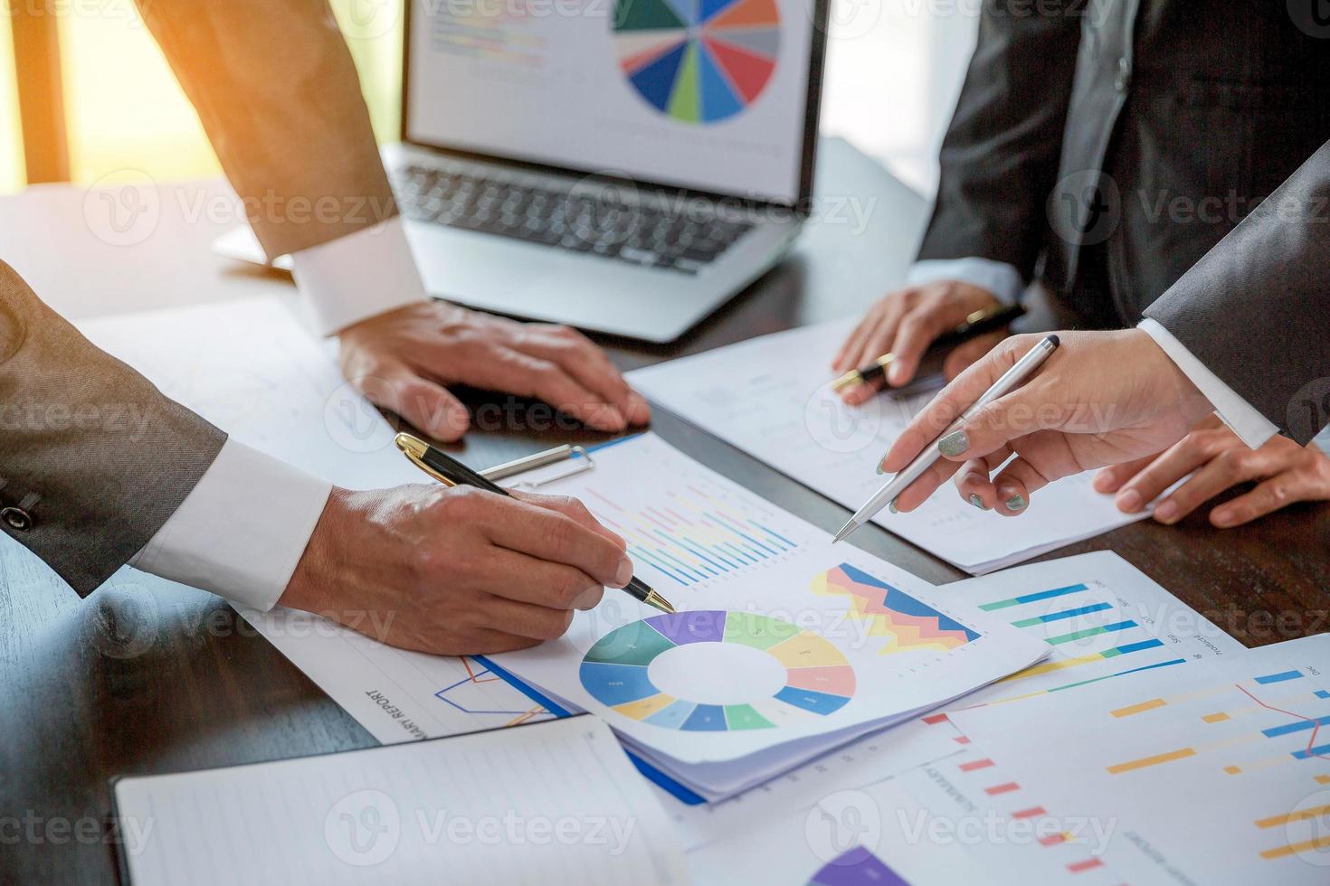Group professional business people person working together to analyze in office, work together to discuss company financial statistics report, brainstorm ideas, and graph datum documents on the table. photo