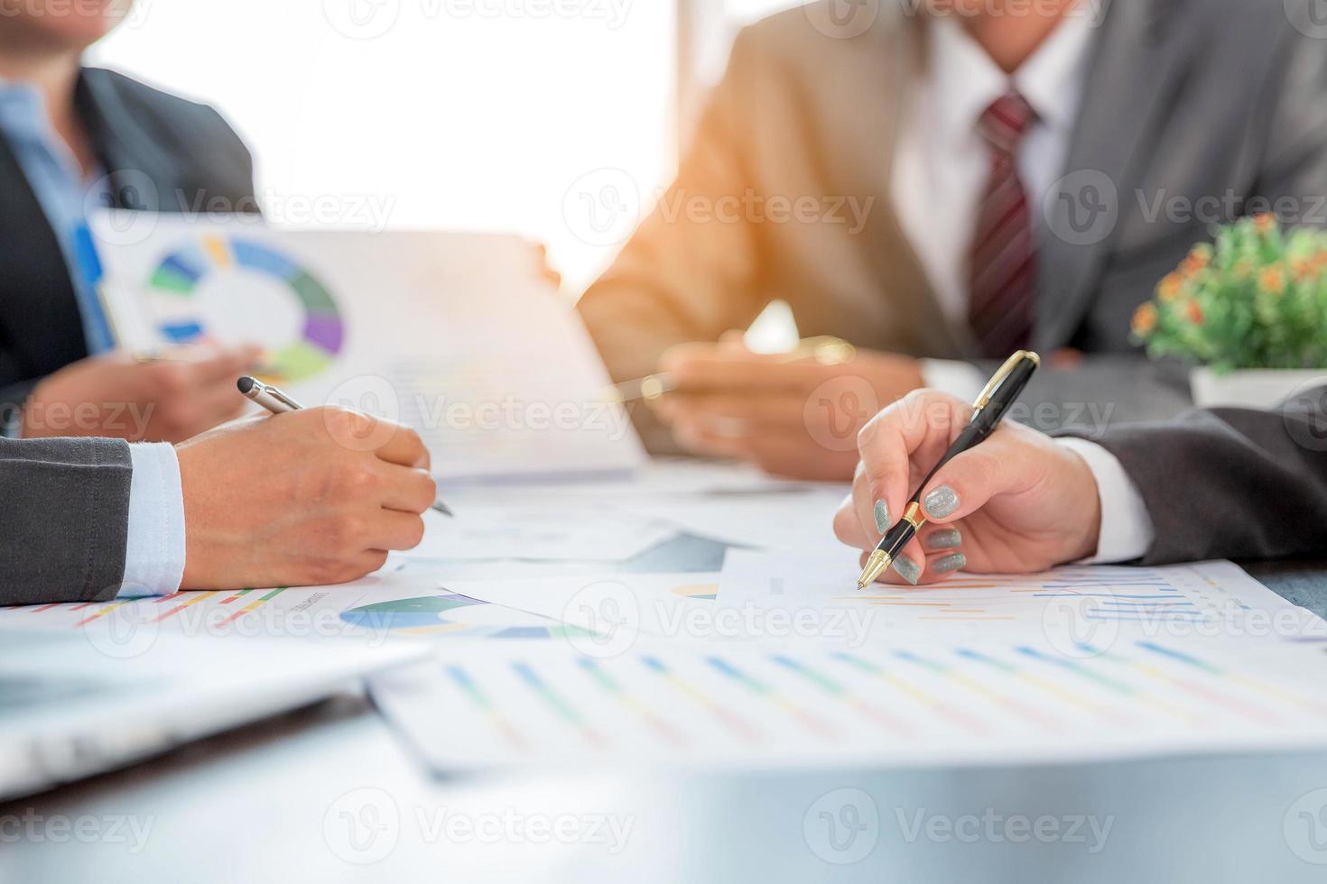 Group professional business people person working together to analyze in office, work together to discuss company financial statistics report, brainstorm ideas, and graph datum documents on the table. photo