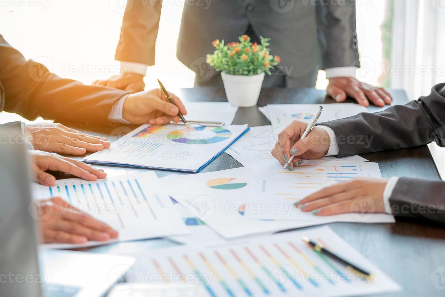 Group professional business people person working together to analyze in office, work together to discuss company financial statistics report, brainstorm ideas, and graph datum documents on the table. photo