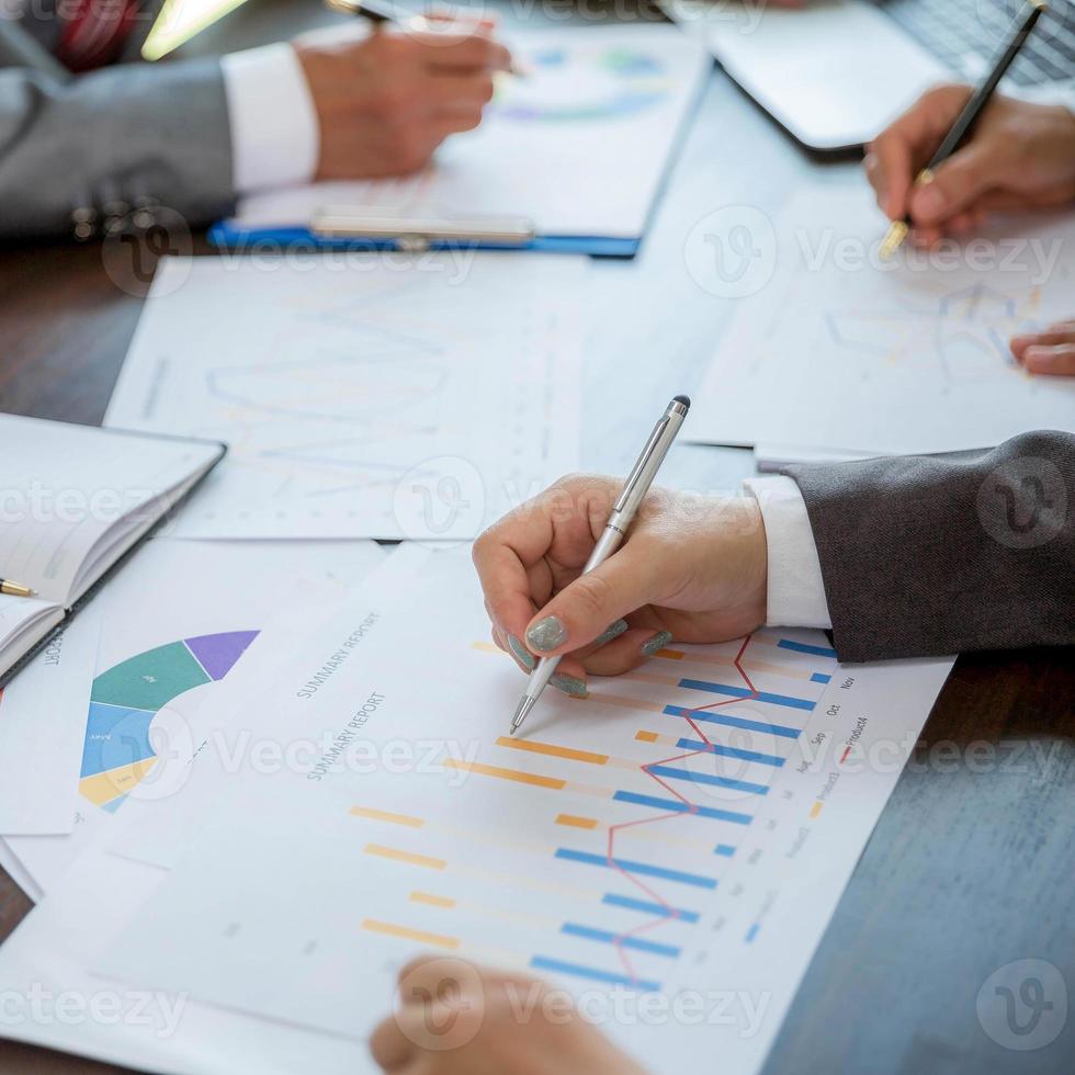 Group professional business people person working together to analyze in office, work together to discuss company financial statistics report, brainstorm ideas, and graph datum documents on the table. photo