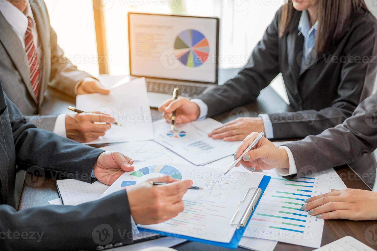 Group professional business people person working together to analyze in office, work together to discuss company financial statistics report, brainstorm ideas, and graph datum documents on the table. photo