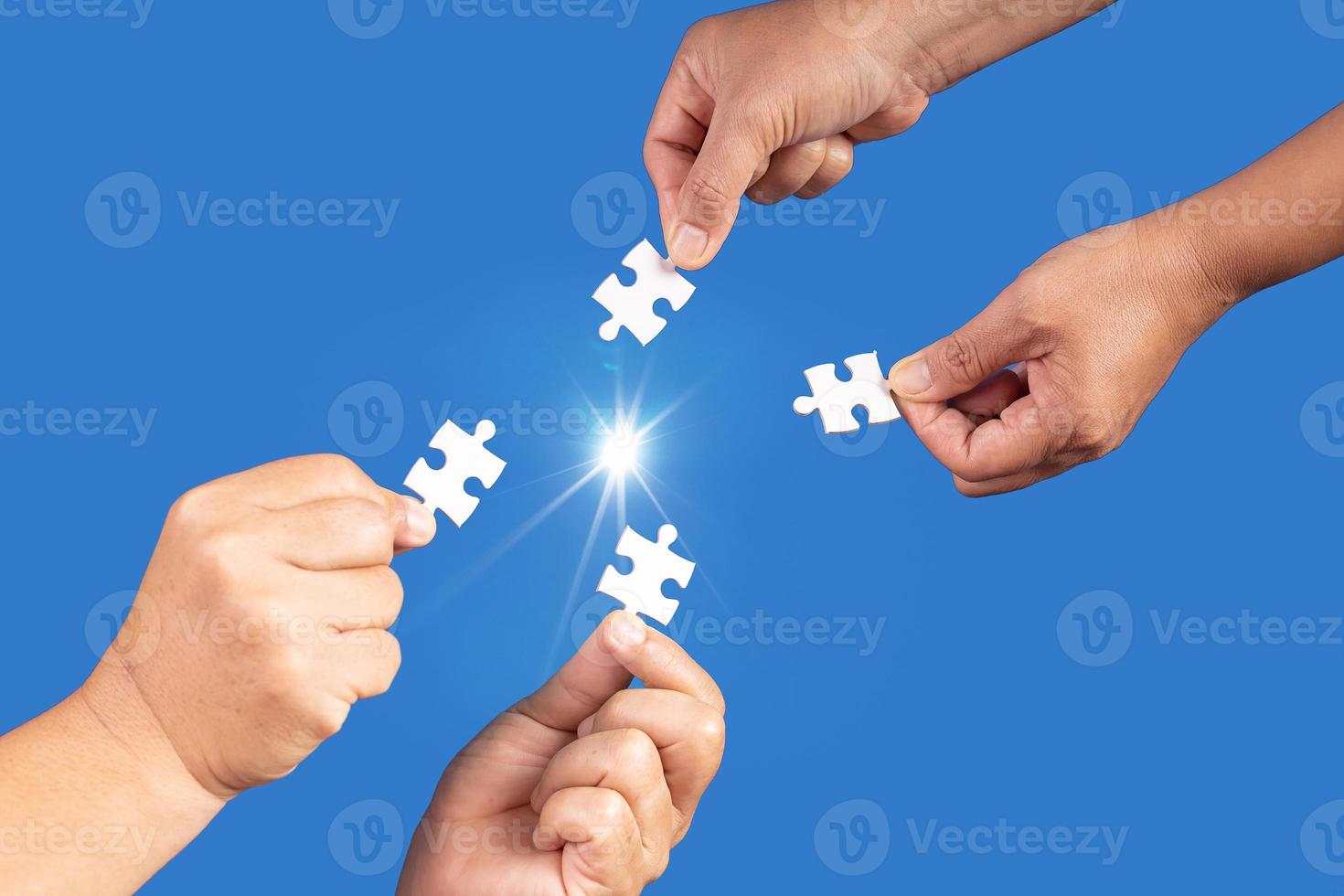 Hands holding jigsaw puzzles piece with clear blue background, success business, solution strategy, teamwork partnership concept photo