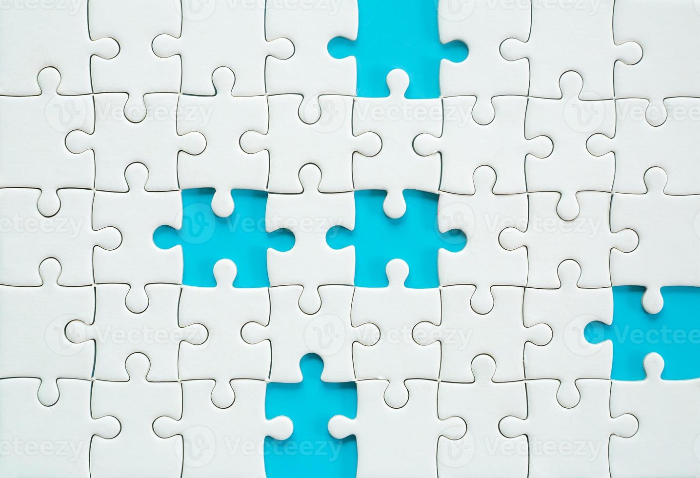 White part of jigsaw puzzle pieces on blue background. concepts of problem solving, business success, teamwork, Team playing jigsaw game incomplete, Texture photo with copy space for text