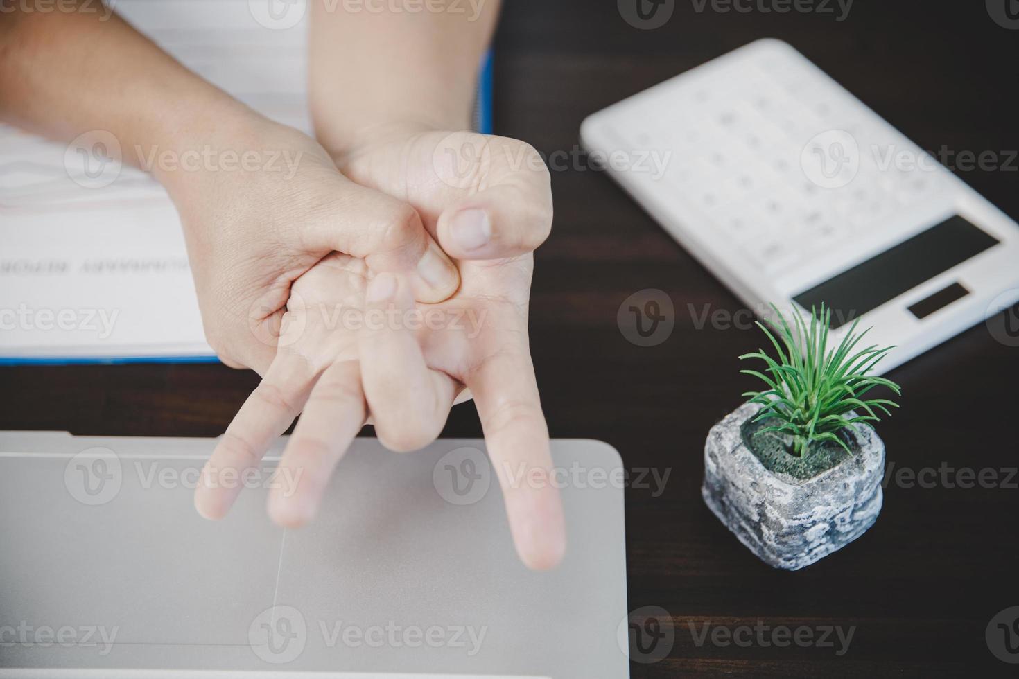 Arthritis person, finger woman ache from working in office. Concept office syndrome hand pain from occupational disease, woman having wrist pain from using laptop computer, wrist pain. photo