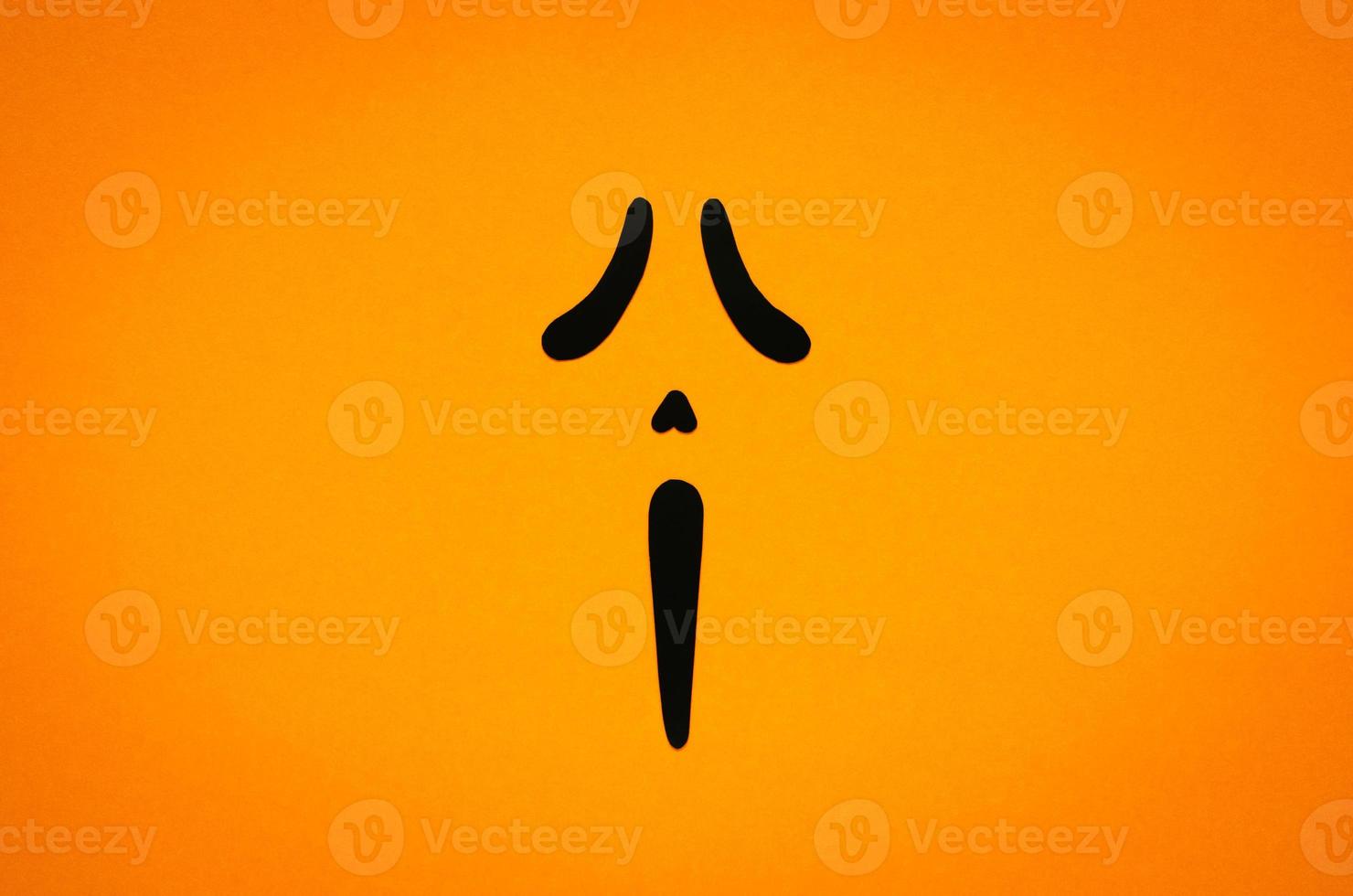 Spooky ghost face with orange background for Halloween minimal background concept. photo