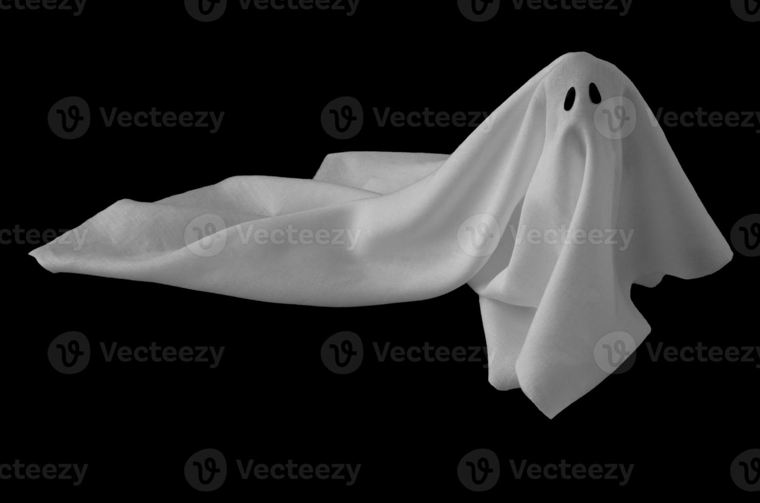 White ghost sheet costume rise up from the floor with black background. Minimal Halloween scary concept. photo