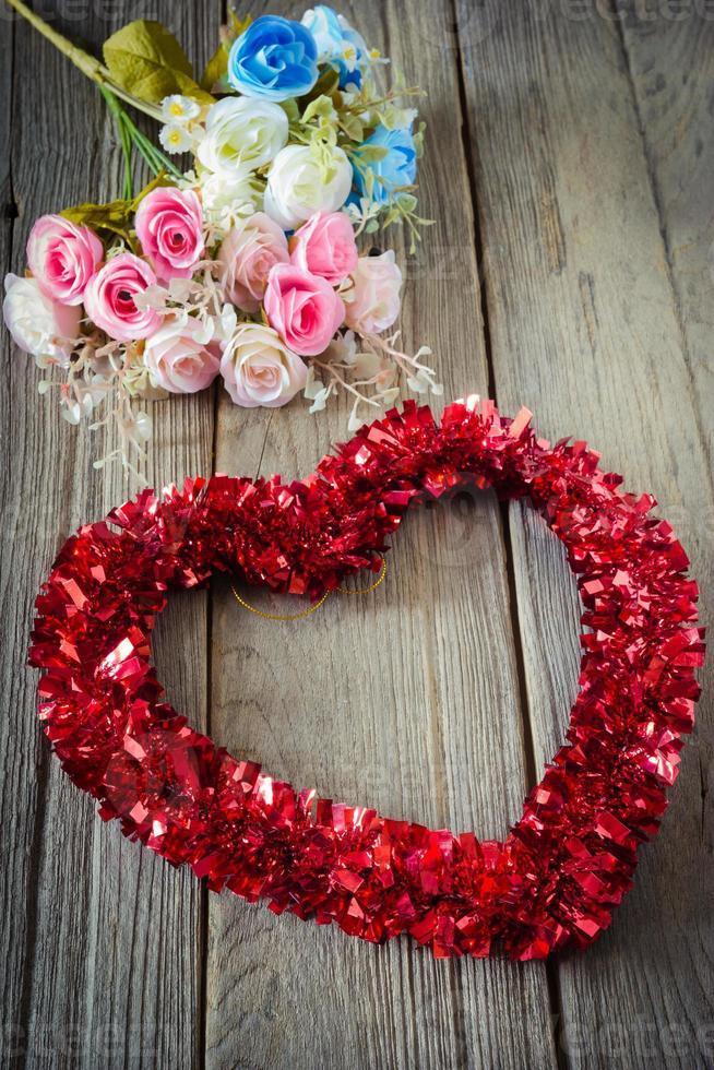 Tinsel heart  decoration on wood background,vintage photo