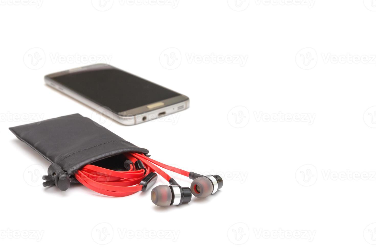 red earphone and black bag isolated on white background photo