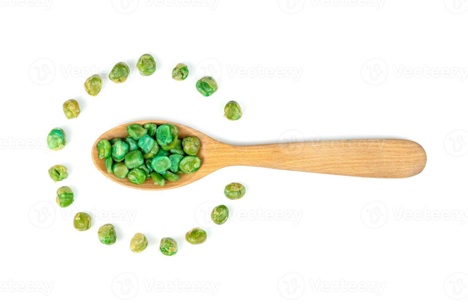 Green peas roasted in wooden spoon isolated on white background photo