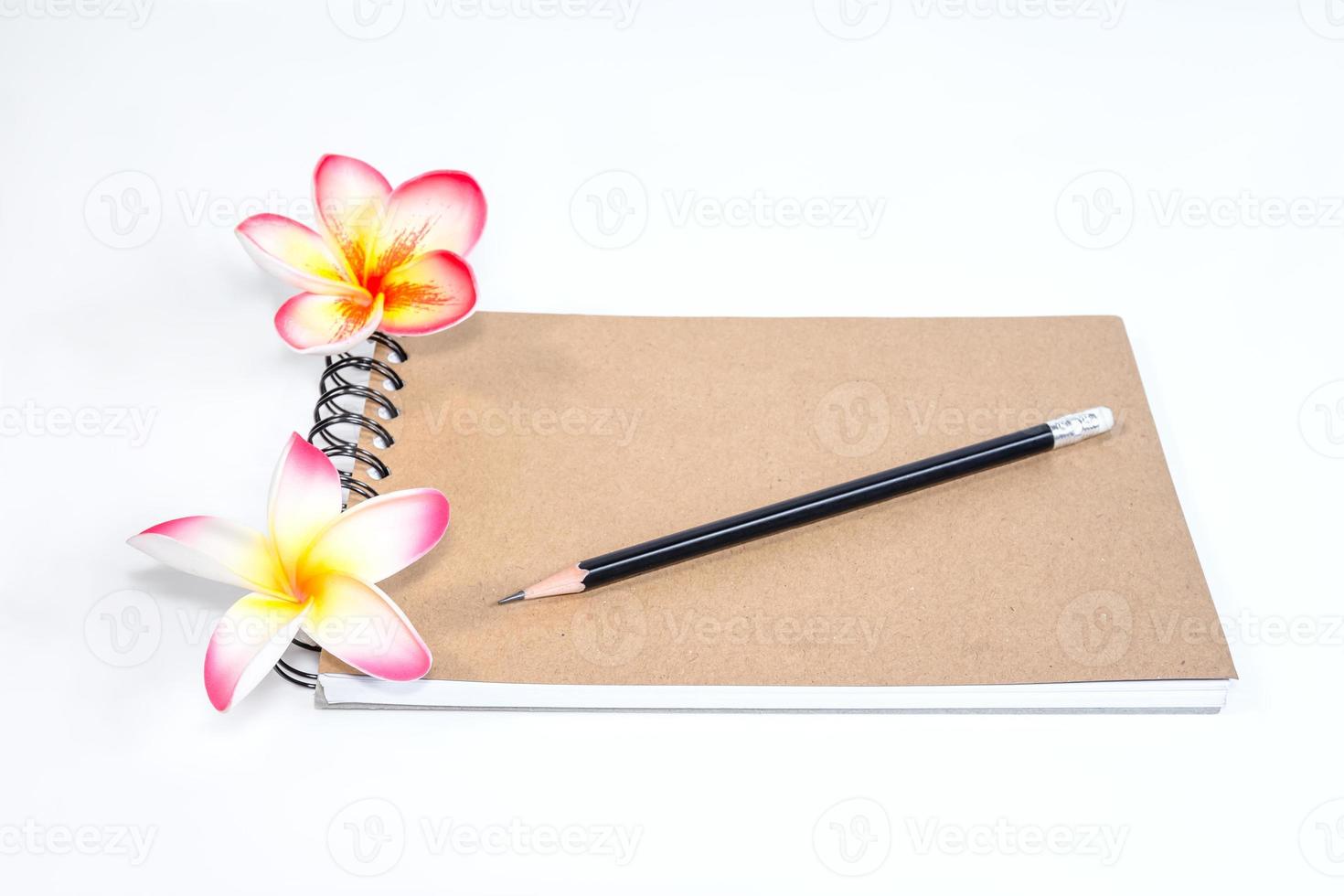 closeup close note book with pencil on background photo
