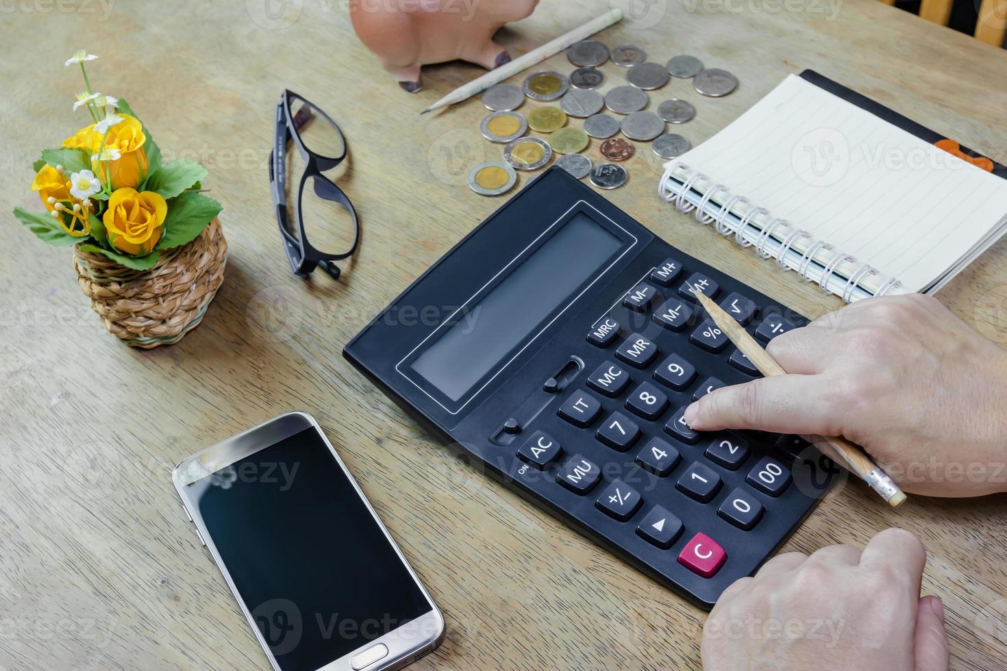 Woman using calculator on desktop photo