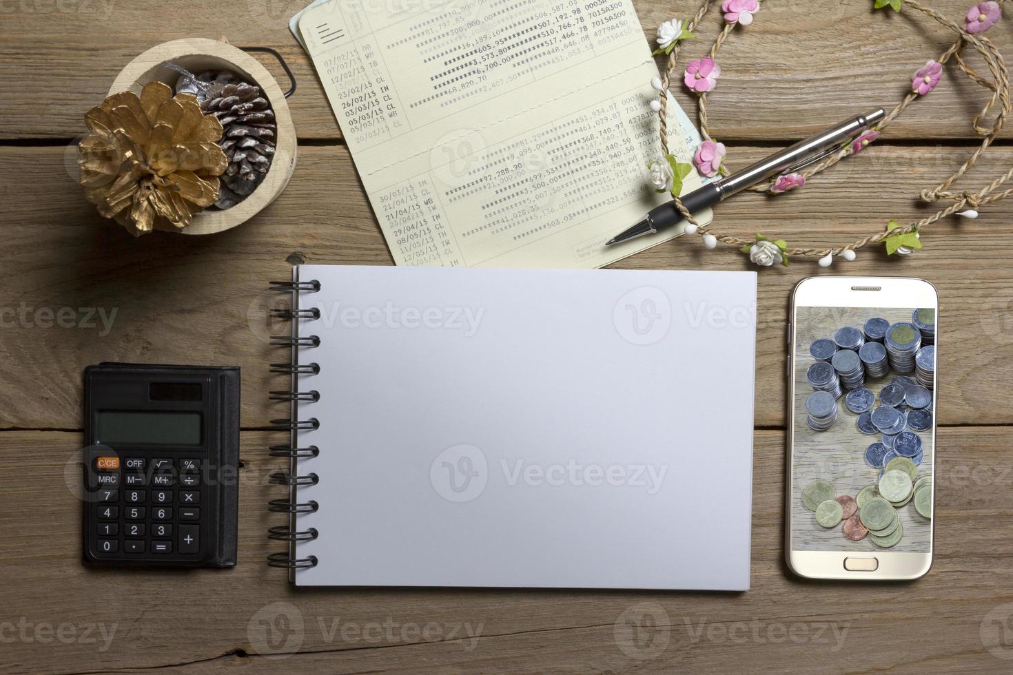 notebook with smartphone and account book on wood background,Business concept photo
