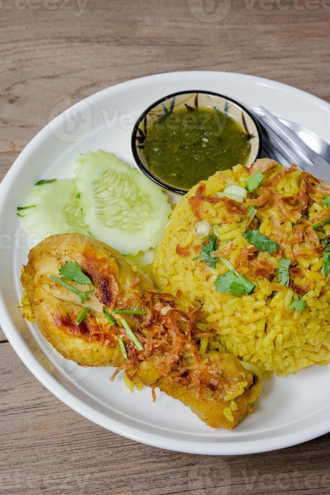 Chicken Biryani with cooked turmeric jasmine on wood background 10713907 Stock Photo at Vecteezy