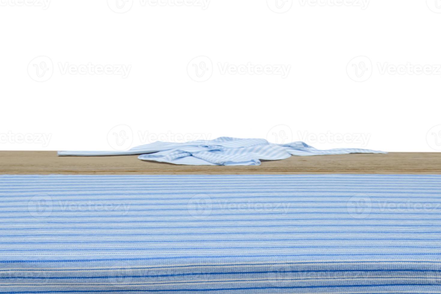 Wooden table with fabric isolated on white photo